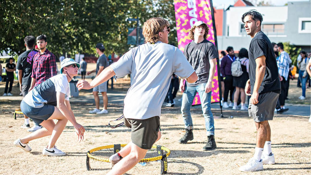 UFV students play spikeball on the green