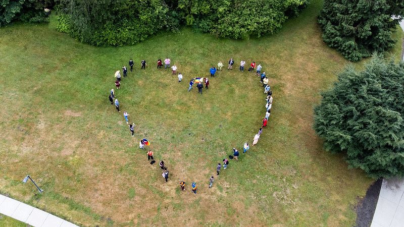 A drone shot of the campus green showing UFV staff and students forming a heart shape