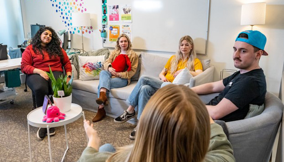 A group of students in the student wellness lounge in conversation