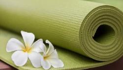 A yoga mat with a flower